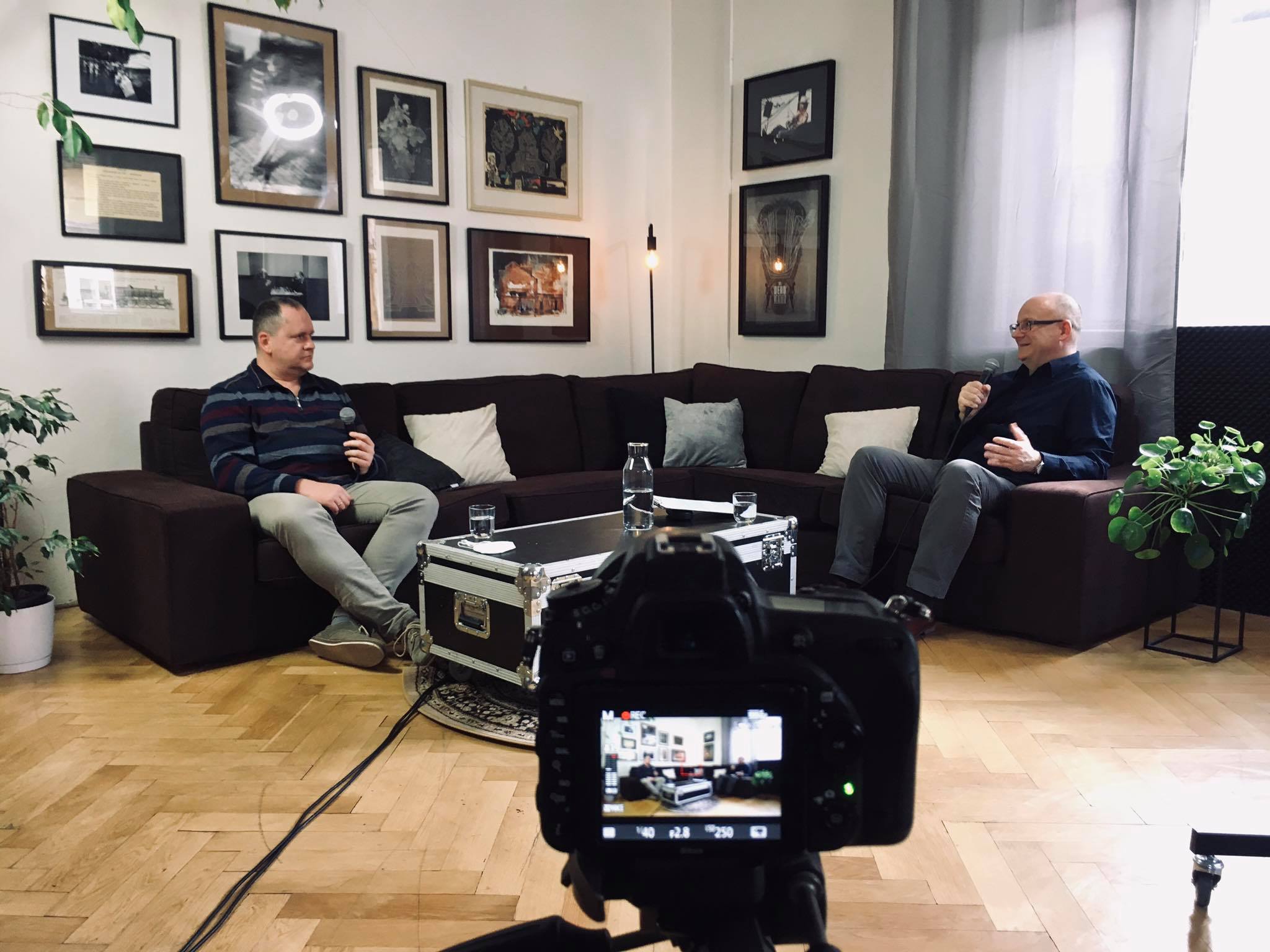 Branislav Moťovský a Ivan Ježík sediaci na gauči počas rozhovoru, v popredí displej fotoaparátu
